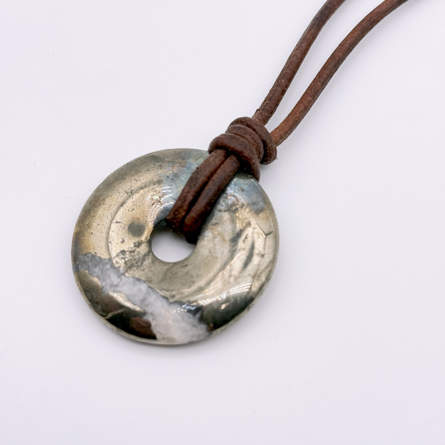 Pyrite donut necklace on leather