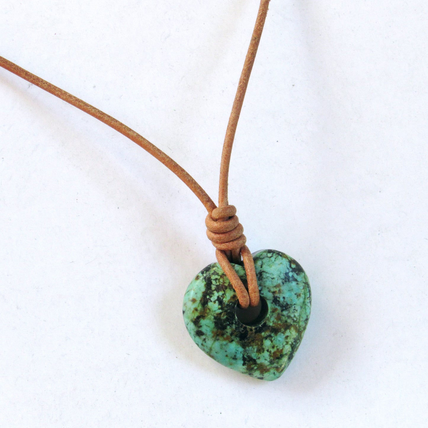African Turquoise gemstone heart on natural leather with copper clasp