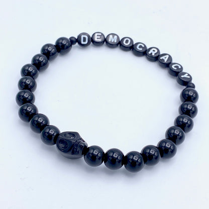 Black obsidian and howlite gemstone skull Democracy bracelet