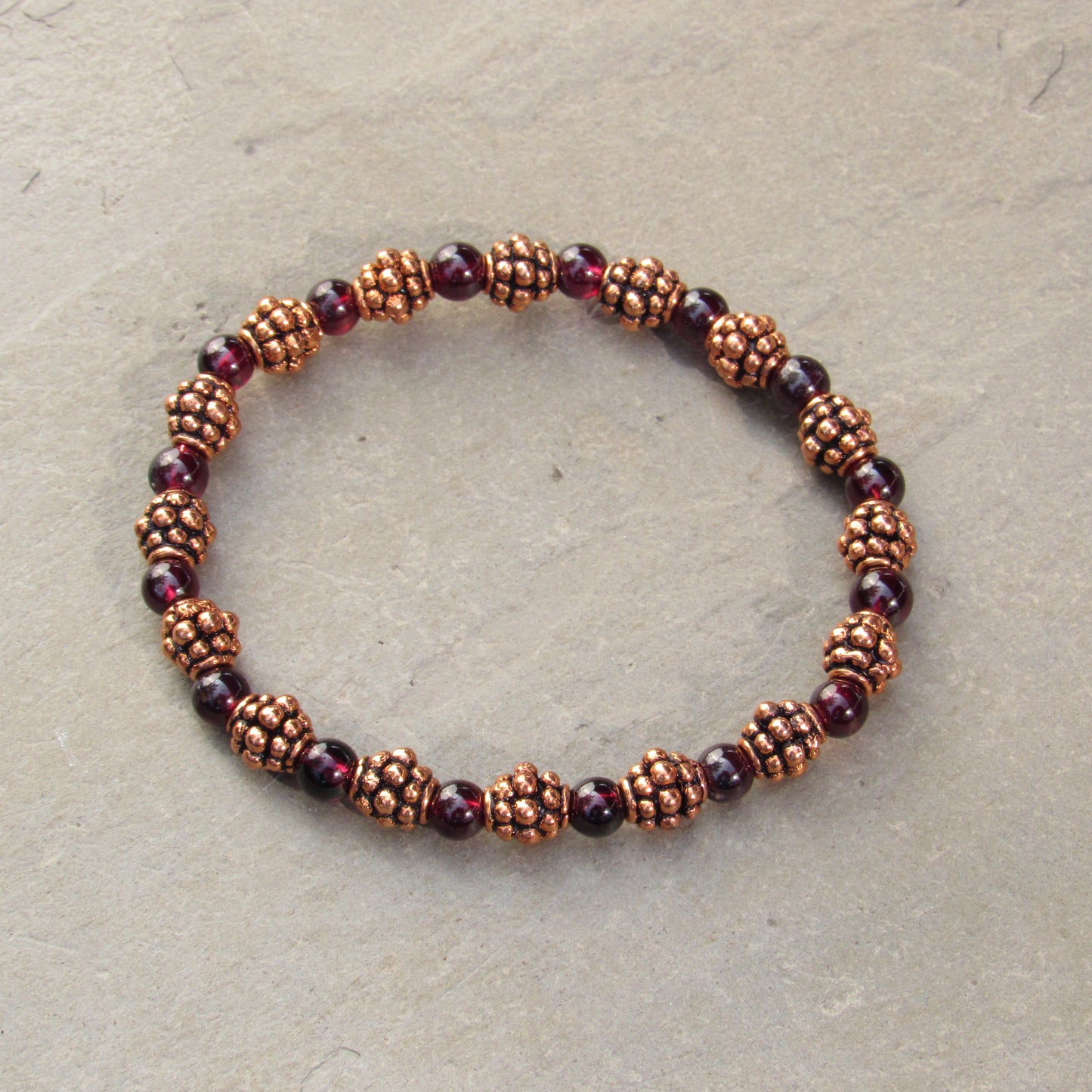 Garnet gemstones and copper bracelet