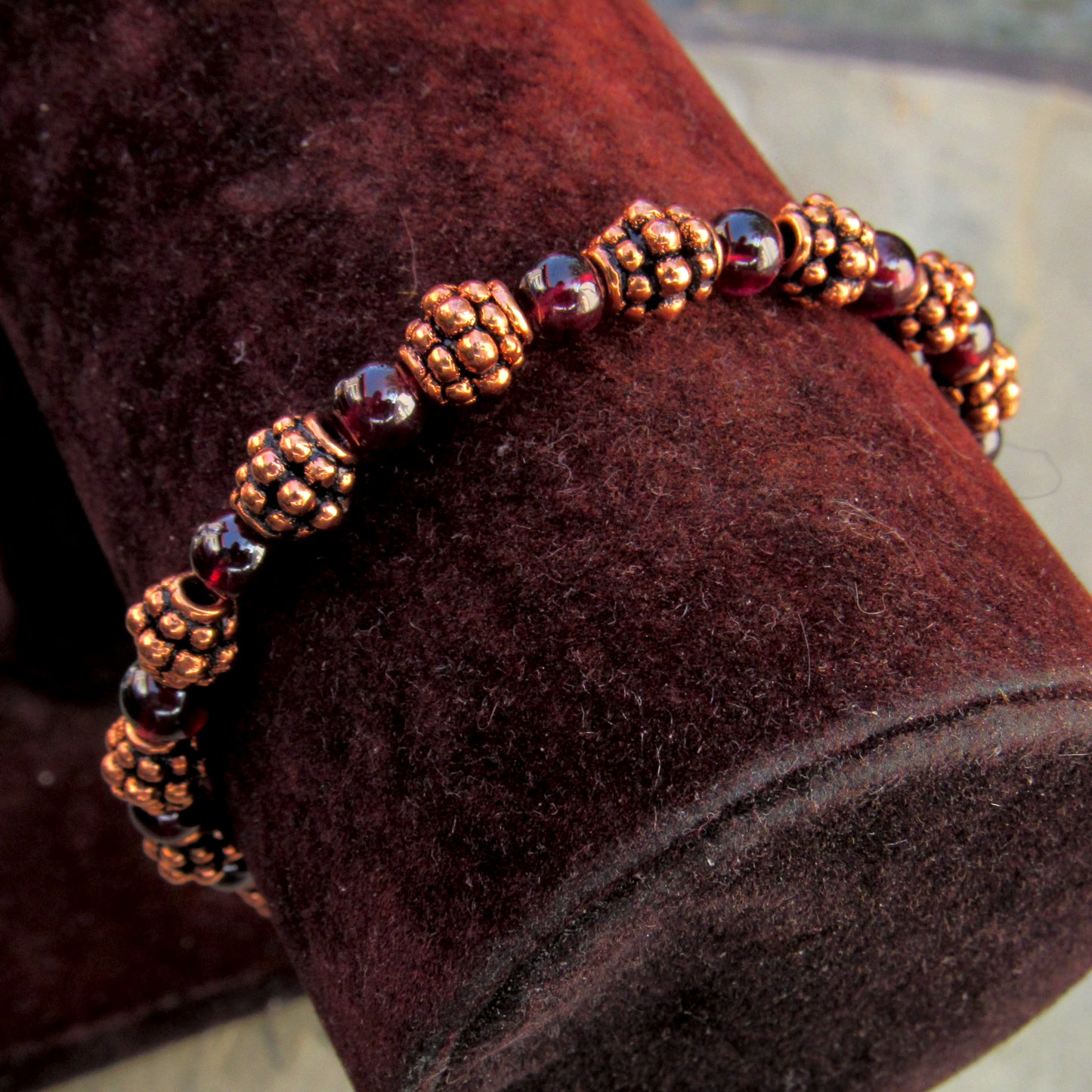 Garnet gemstones and copper bracelet