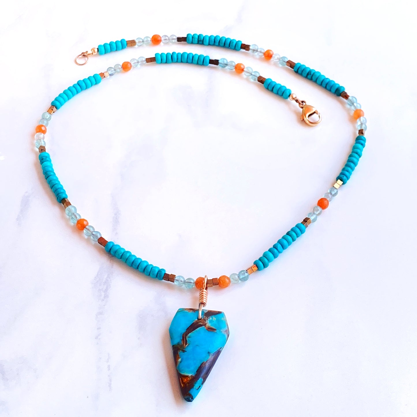 Bornite gemstone arrowhead pendant on Blue Howlite beaded necklace