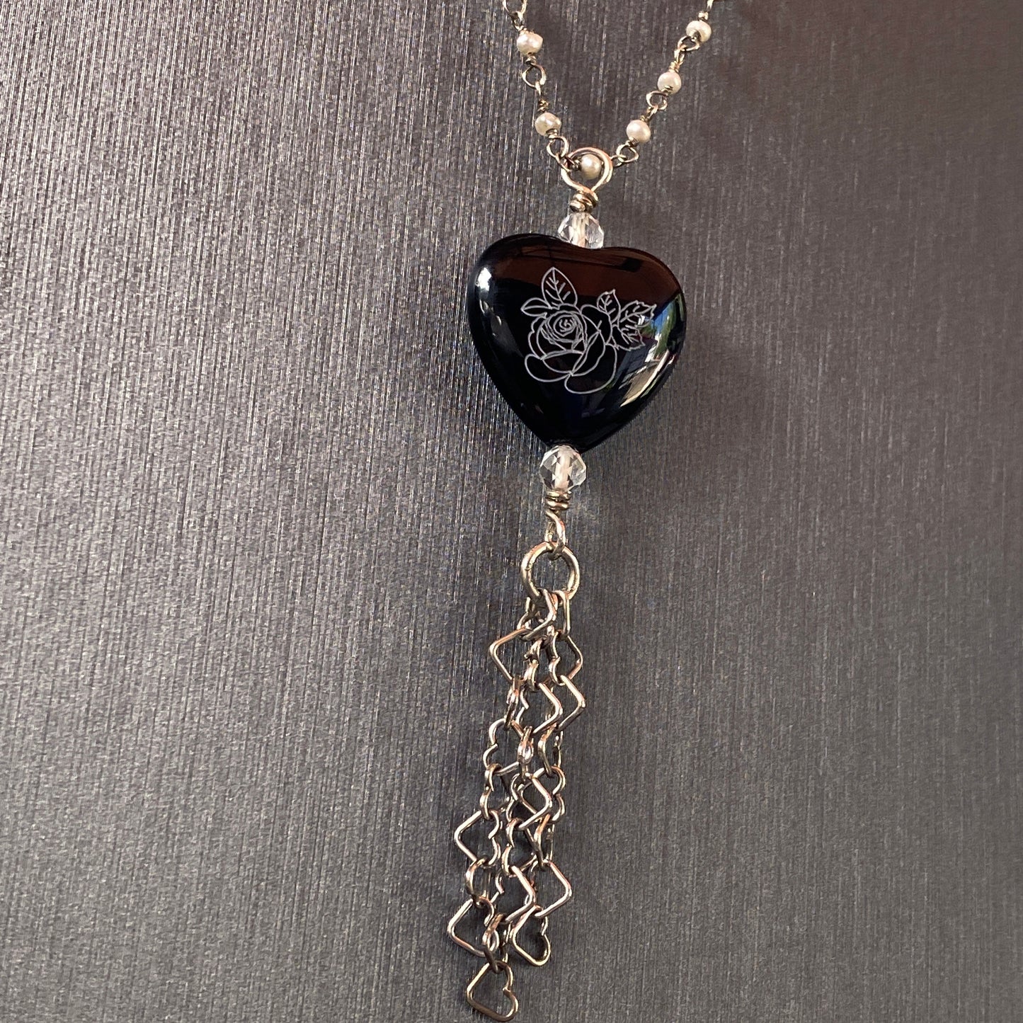 Sterling silver with freshwater pearls, painted onyx pendant, white topaz, hanging heart chain