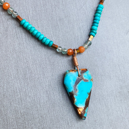 Bornite gemstone arrowhead pendant on Blue Howlite beaded necklace