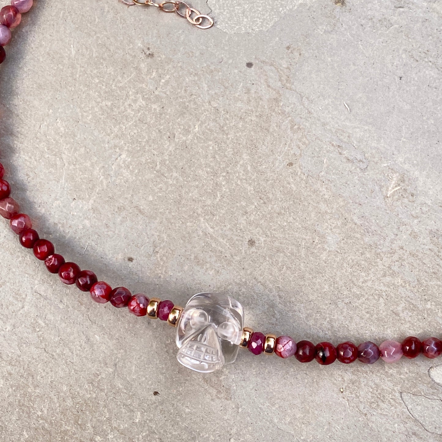 Clear quartz gemstone Skull with Rubies and fire agates and 14 kt rose gold