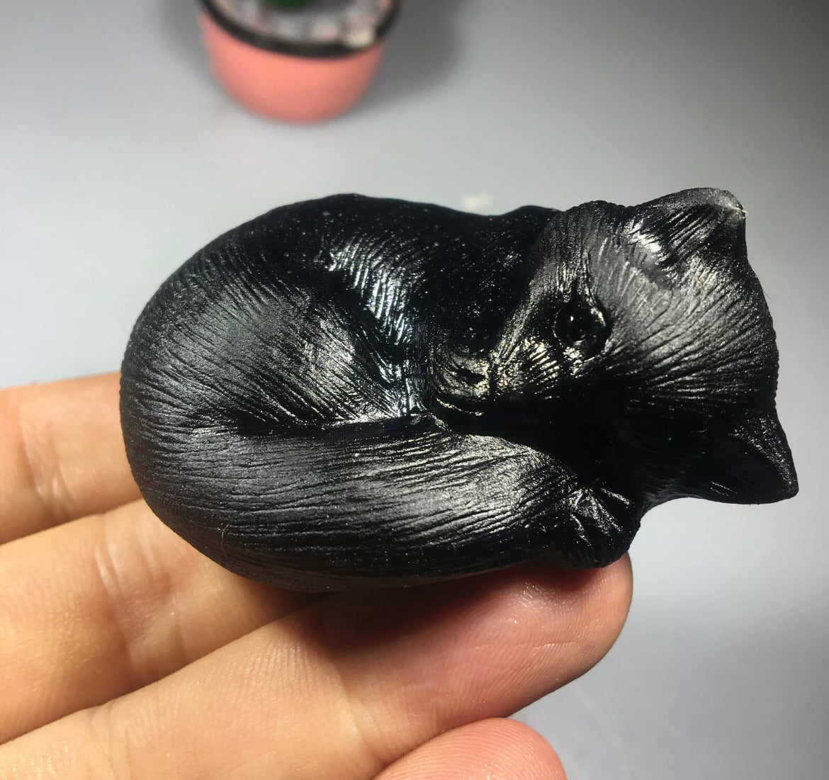 Black obsidian gemstone carved sleeping kitty cat