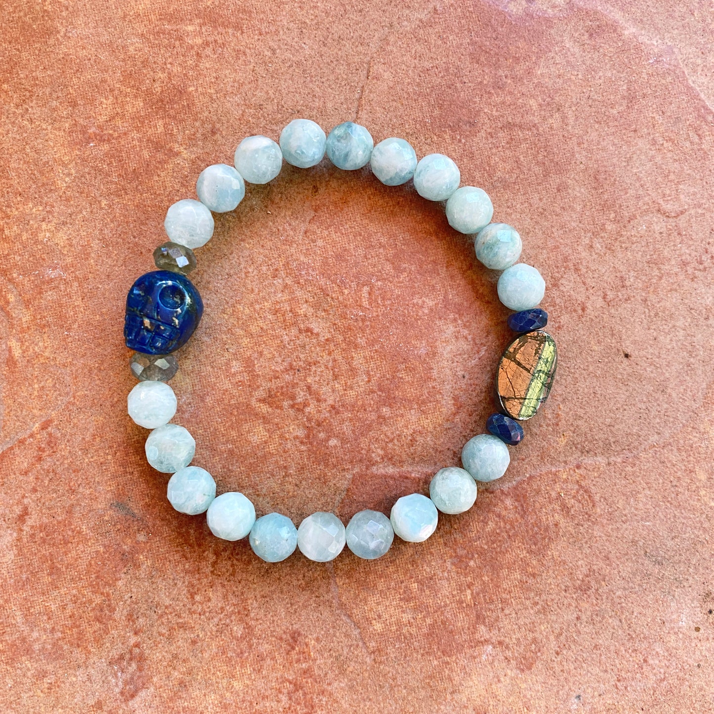Lapis lazuli skull, pyrite, Labradorite, and blue sapphire stretch bracelet